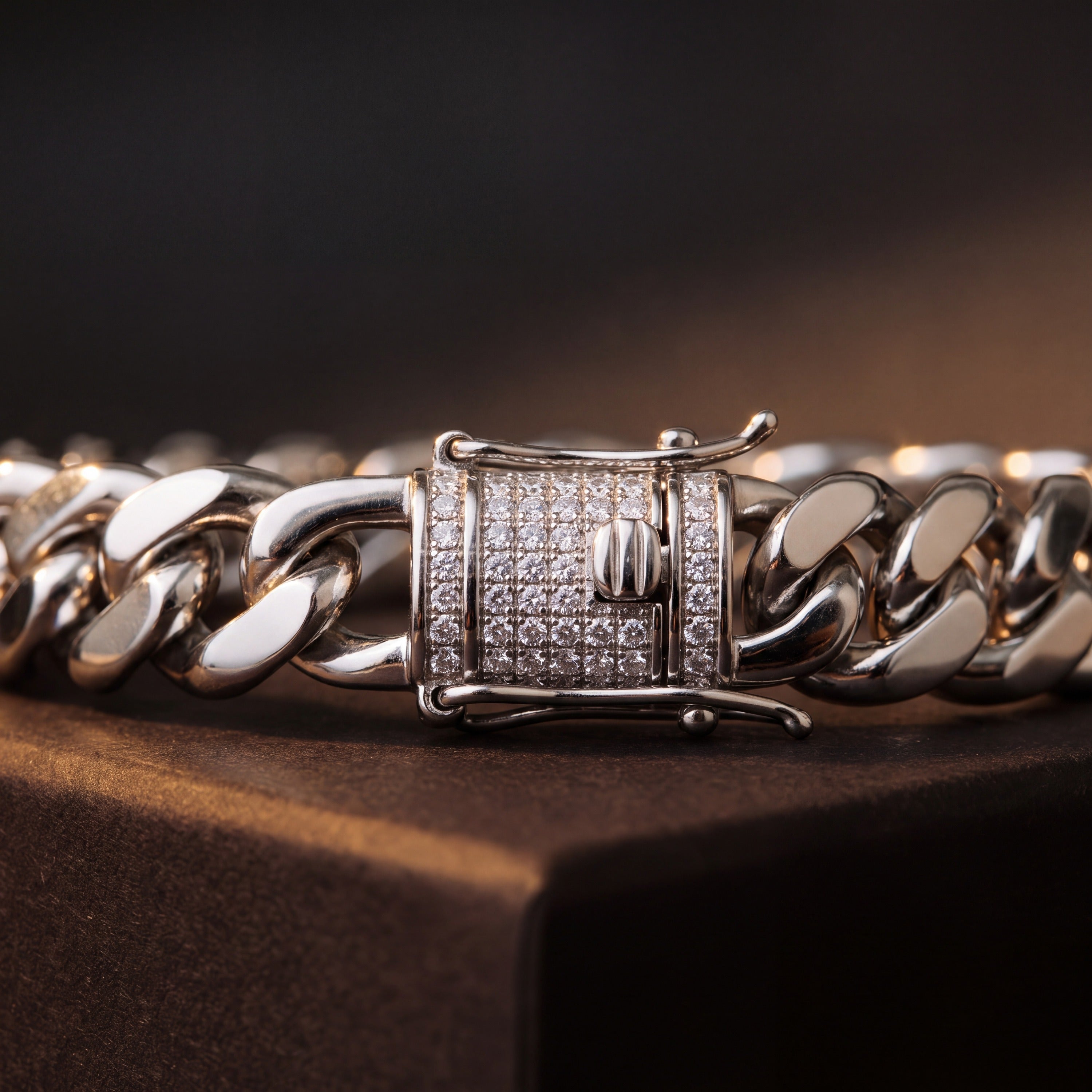 Detail of the box clasp and side latches on a stainless steel Cuban link bracelet